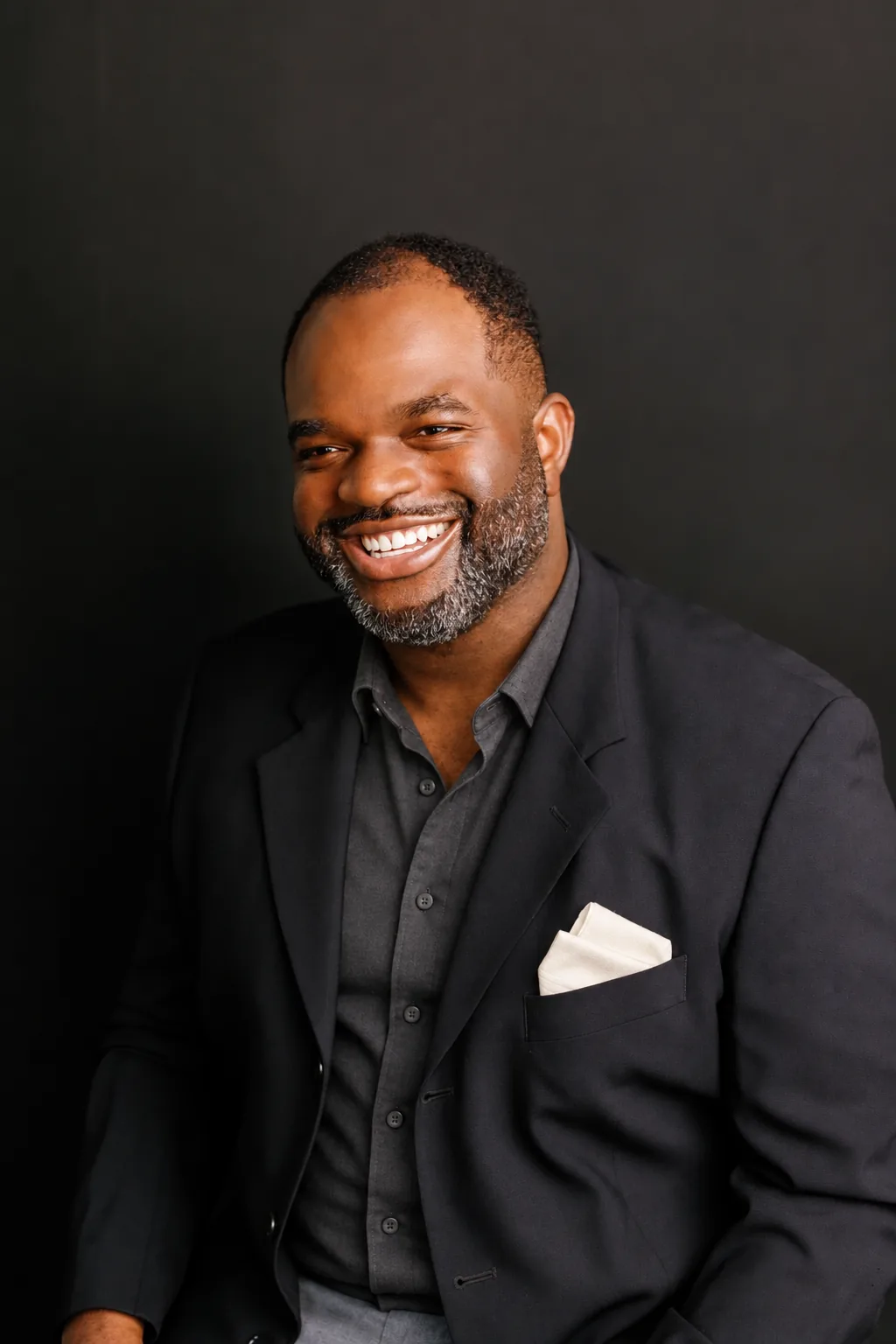 Dr. Olawale Osinusi in a dark blazer